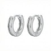 Textured Huggie Hoops, Polished Borders – sterling silver earrings, close-up