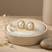 Pearl Studs in Sculptural Gilded Setting – pearl earrings, close-up