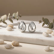 Teardrop Studs with Sculptural Wave – sterling silver earrings, close-up